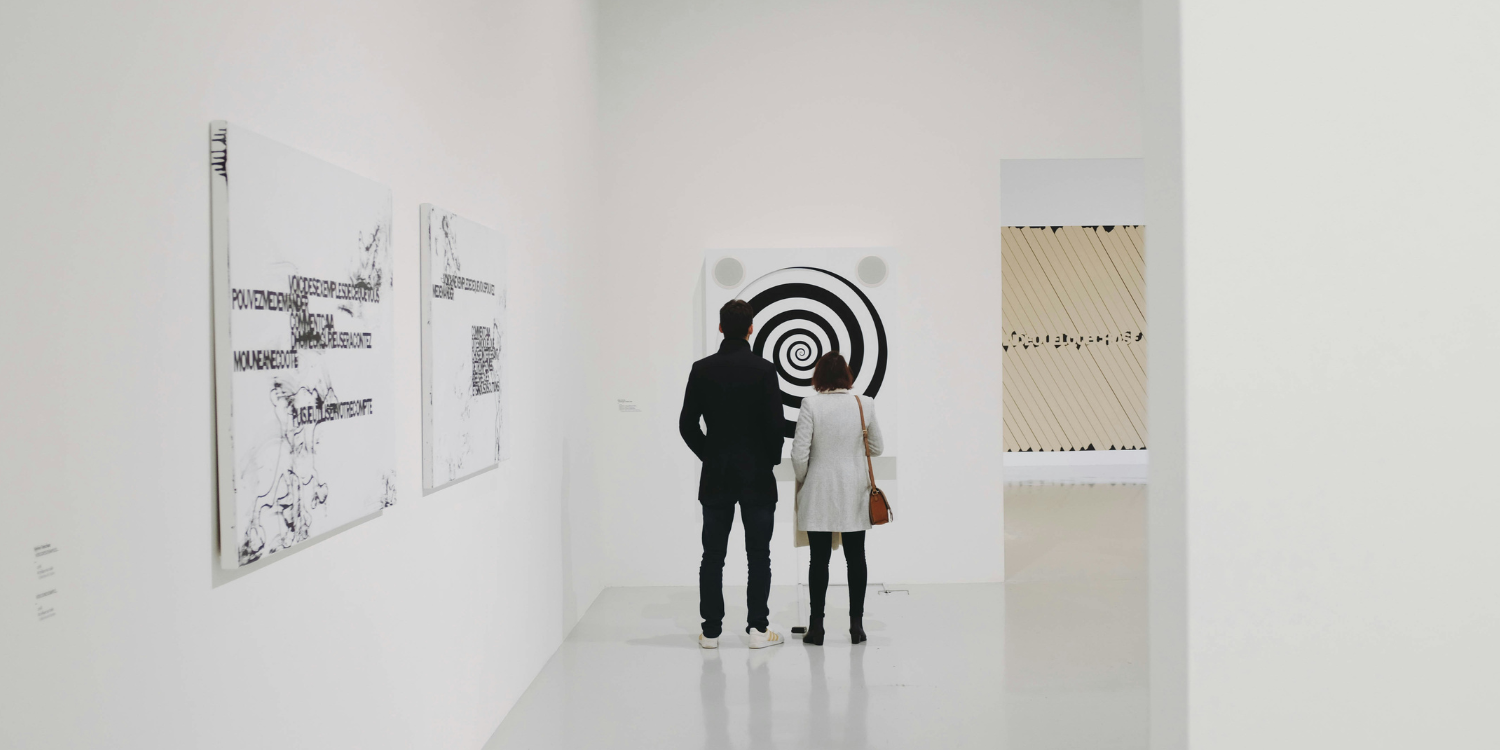 Zwei Personen vor einem Kunstwerk in einer Ausstellung